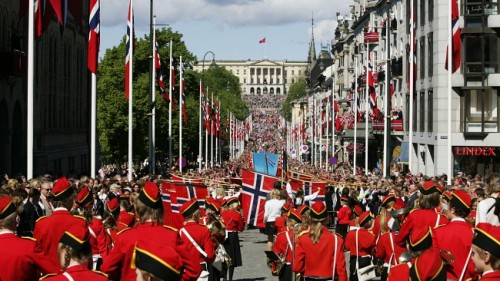 Hoards of people in parade approaching the palace