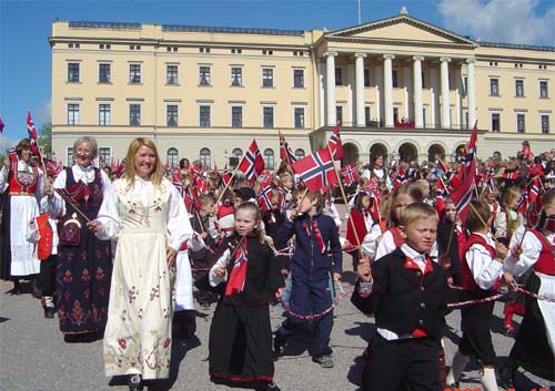 Children parade with castle in background.