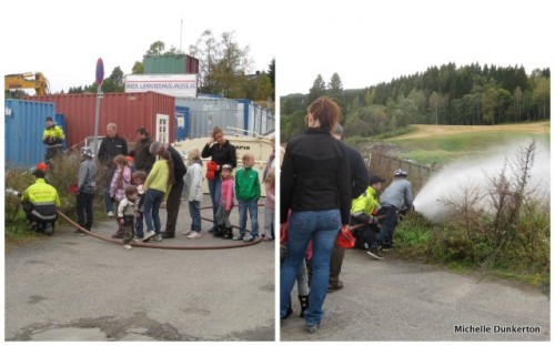 Kids lined up and trying hand at using firehose